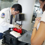 SAN FRANCISCO - AUGUST 5: A Transportation Security Administration screener inspects a bag at the international terminal of San Francisco International Airport August 5, 2003 in San Francisco, California. The TSA told screeners today to pay close attention to cameras, laptop computers and cell phones, addressing a concern that terrorists could attempt to hide explosives in electronic devices. (Photo by Justin Sullivan/Getty Images)