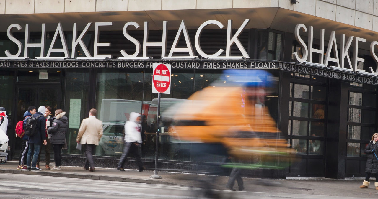 CHICAGO, IL - JANUARY 28: A sign hangs over the entrance of a Shake Shack restaurant on January 28, 2015 in Chicago, Illinois. The burger chain, with currently has 63 locations, is expected to go public this week with an IPO priced between $17 to $19 a share. The company will trade on the New York Stock Exchange under the ticker symbol SHAK. (Photo by Scott Olson/Getty Images)