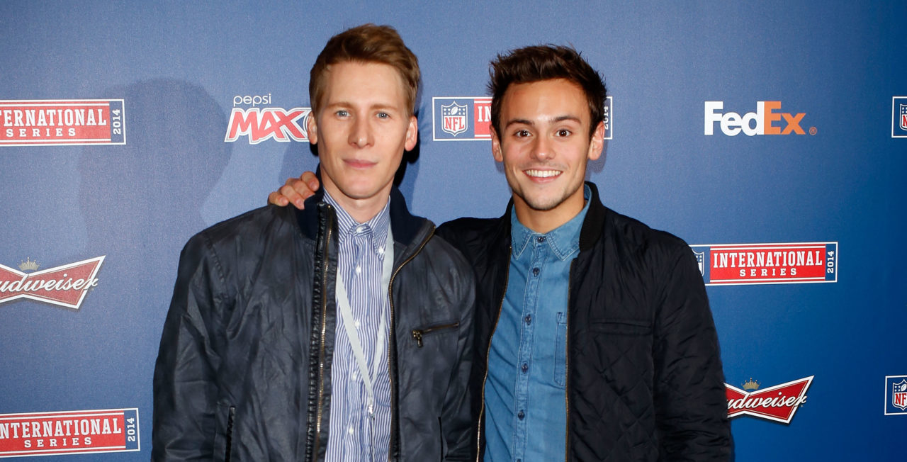 LONDON, ENGLAND - NOVEMBER 09: Dustin Lance Black and Tom Daley attend as the Dallas Cowboys play the Jacksonville Jaguars in an NFL match at Wembley Stadium on November 9, 2014 in London, England.