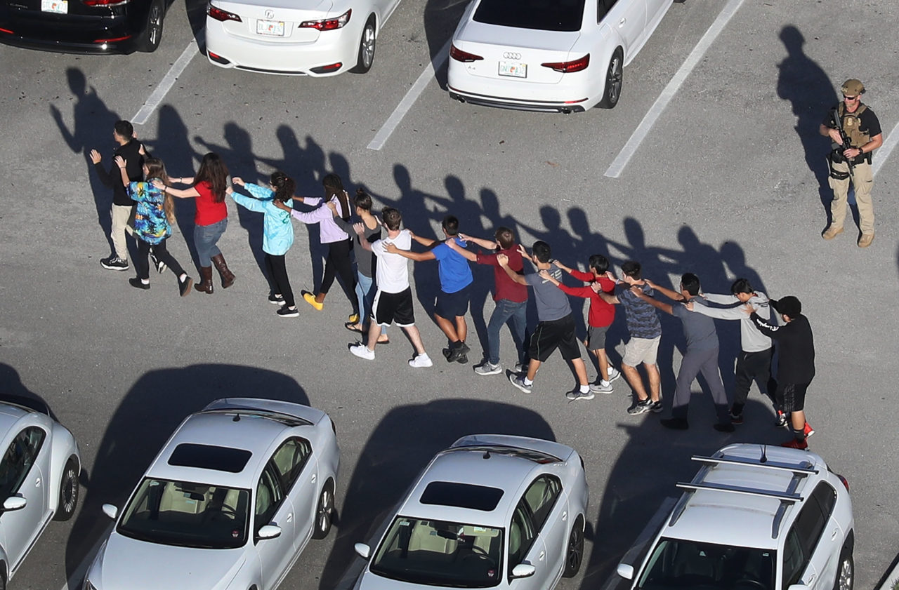 PARKLAND, FL - FEBRUARY 14: People are brought out of the Marjory Stoneman Douglas High School after a shooting at the school that reportedly killed and injured multiple people on February 14, 2018 in Parkland, Florida. Numerous law enforcement officials continue to investigate the scene.