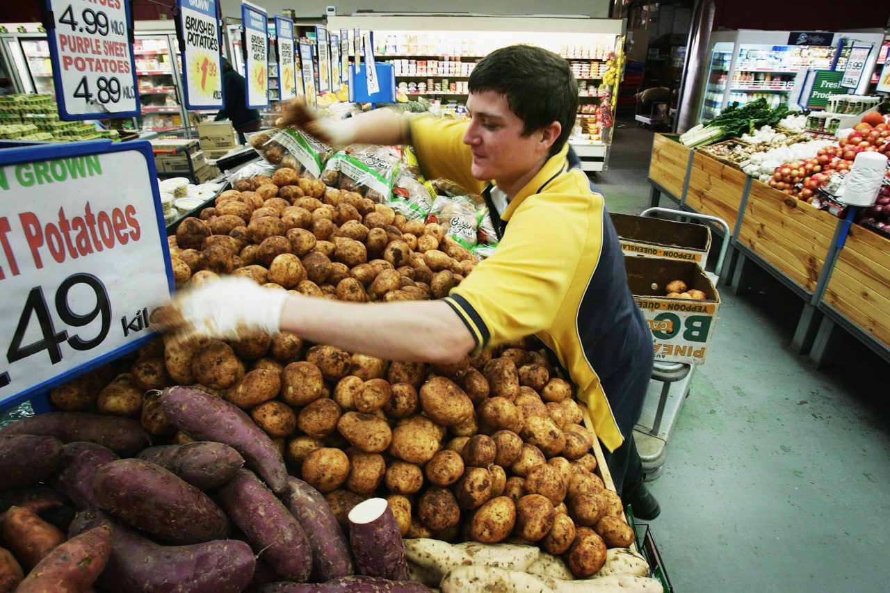 SYDNEY, NSW - JULY 28: A supermarket employee stacks potatoes July 28, 2006 in Sydney, Australia. Prices in Australia have reached a 15-year high, showing an 8.3 per cent rise in food costs, which are being blamed for a big jump in inflation. The rise was mainly driven by hugely escalating banana prices - after cyclone Larry devastated most of Australia's plantations - with fruit prices up 52 per cent for the June quarter. (Photo by Ian Waldie/Getty Images)