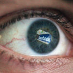 Facebook's logo reflected in an eyeball.