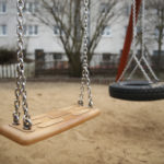 A swing stands at a playground.