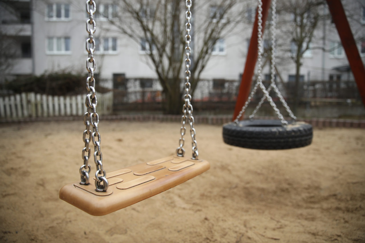 A swing stands at a playground.