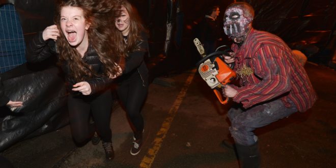 LONDONDERRY, NORTHERN IRELAND - OCTOBER 31: Thrill seekers react to a Chateau Le Fear cast member as he performs at the house of horror interactive walk-through show on October 31, 2015 in Londonderry, Northern Ireland. Derry hosts the biggest Halloween street carnival parade in Europe attracting some 25,000 enthusiasts and was also recently voted the number one Halloween destination in the world according to a USA Today poll. (Photo by Charles McQuillan/Getty Images)