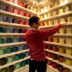 A man looks at paint swatches.