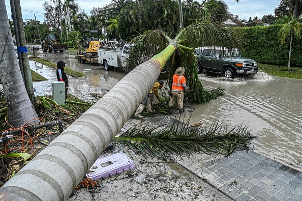 Workers carry out debris cleanup and fallen trees after the passage of Hurricane Ian on in Naples F...